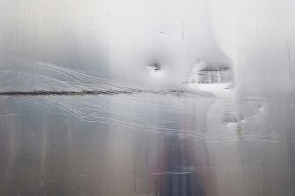 A close-up look at a dented metal surface A close-up look at a dented metal surface